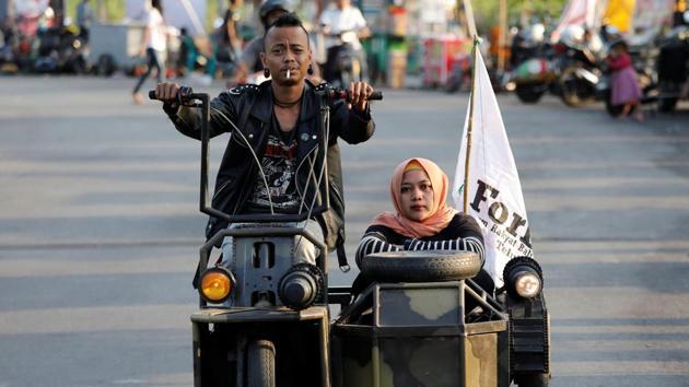 Extreme Vespa enthusiasts drive near the site of a scooter festival in Kediri, East Java, Indonesia. Every year, Indonesians from teens and grandads, to mechanics and students, gather in eastern Java to celebrate their love of the iconic Italian scooter. (Darren Whiteside / REUTERS)