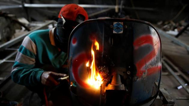 A mechanic works on turning an old Vespa bike into an extreme tank to sell, at a workshop in Kediri. For some, it’s an ‘extreme’ kind of love, where the vehicles are customised to resemble metallic monster bikes straight out of a Hollywood dystopia. (Darren Whiteside / REUTERS)