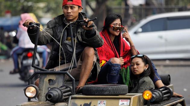 Hundreds of enthusiasts travel to the festival in Kediri to show off their creations – ranging from restored vintage Vespas to Mad Max-style tanks fitted with fake machine guns, a dozen extra tyres, or eerie stuffed toys as hood ornaments. (Darren Whiteside / REUTERS)