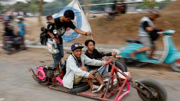 Vespa enthusiasts ride after attending a weekend festival for extreme Vespas in Semarang. Peded, a 43-year-old grandfather who has been modifying Vespas since the 1990s, says he likes his scooter to “tell a story”. His own Vespa sports massive buffalo horns from the Toraja tribal land on Sulawesi island. (Darren Whiteside / REUTERS)
