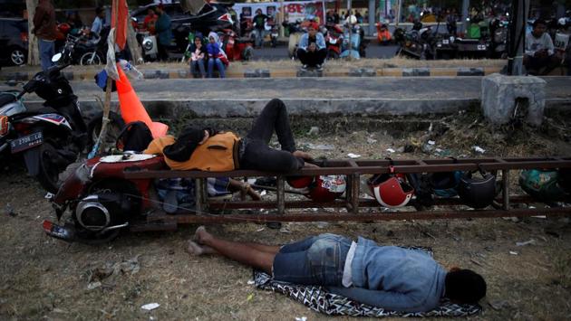 Extreme Vespa enthusiasts sleep during a weekend scooter festival in Kedir. “Extreme Vespa guys, we stick together. If we have trouble on the road, they will wait and help us out until we can ride again,” Ningsih added. (Darren Whiteside / REUTERS)