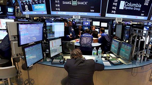 A trader waits on a nearly empty trading floor at the New York Stock Exchange (NYSE) after trading was halted due to a 'technical glitch' in New York City.(AFP)