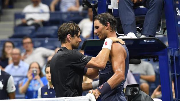 Rafael Nadal of Spain (L) and David Ferrer of Spain meet at the net after Ferrer retired during their 2018 US Open men's Singles match at the USTA Billie Jean King National Tennis Center in New York on August 27, 2018. - World number one and defending US Open champion Rafael Nadal sent his close friend David Ferrer into Grand Slam retirement on Monday when his veteran compatriot was forced to quit their first round match with an injury.(AFP)