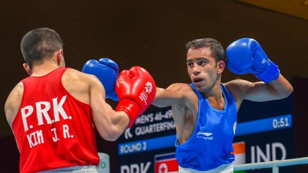 Jakarta: India's Amit Panghal (Blue) and PR Korea's Ryong Jong compete in the Men's Light Fly (46-49kg) Quarterfinal boxing event. (PTI)