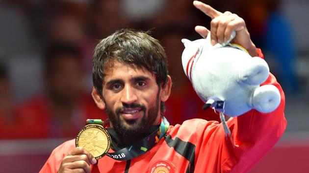 Bajrang Punia poses with his gold medal after winning in the Finals of men's freestyle wrestling (65kg) at Asian Games 2018.(PTI)