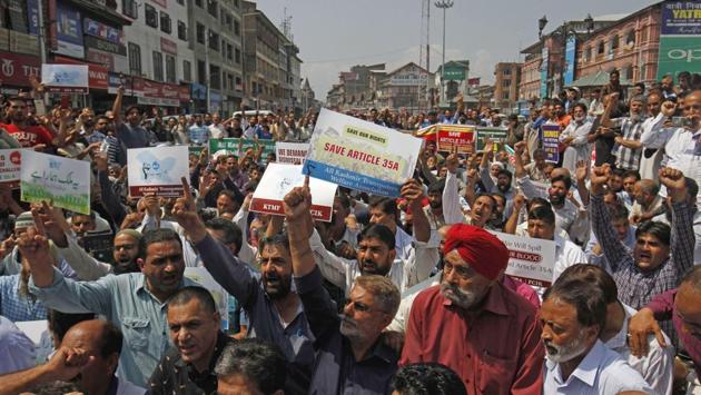 Kashmiri traders shout slogans during a protest against challenging the validity of Article 35A, at Lal Chowk, Srinagar. Dozens of weddings in Kashmir scheduled for August 29, 30 and 31 have either been scaled down or postponed as the Supreme Court is scheduled to hear a bunch of petitions against Article 35 A on Friday. Separatists have called for a two-day shutdown on Thursday and Friday across the state. (Waseem Andrabi / HT Photo) Kashmiri traders shout slogans during a protest against challenging the validity of Article 35A, at Lal Chowk, Srinagar. Dozens of weddings in Kashmir scheduled for August 29, 30 and 31 have either been scaled down or postponed as the Supreme Court is scheduled to hear a bunch of petitions against Article 35 A on Friday. Separatists have called for a two-day shutdown on Thursday and Friday across the state. (Waseem Andrabi / HT Photo)