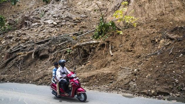 Commuters ride along a road flanked by a hillside damaged by a landslide. Noting that rains and landslides had eroded the top soil and excess moisture damaged the coffee estates, Coffee Board Chairman M.S. Boje Gowda said hundreds of planters and small growers would have to wait a year for the new berries to sprout and ripen. (Prashanth Vishwanathan / Bloomberg) Commuters ride along a road flanked by a hillside damaged by a landslide. Noting that rains and landslides had eroded the top soil and excess moisture damaged the coffee estates, Coffee Board Chairman M.S. Boje Gowda said hundreds of planters and small growers would have to wait a year for the new berries to sprout and ripen. (Prashanth Vishwanathan / Bloomberg)