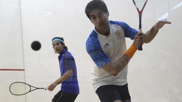 India's Ramit Tandon, right, and Thailand's Arnold Phatraprasit during their men's team squash. (AP)