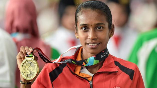 Bronze medallist athlete Chitra poses for photographs at the medal ceremony of women's 1500m event. (PTI) Bronze medallist athlete Chitra poses for photographs at the medal ceremony of women's 1500m event. (PTI)