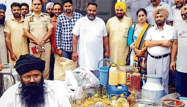Officials of the health department, food safety department and police with the recovered adulterated dairy items at Dhindsa Kharud village near Nabha on Wednesday. (HT Photo) Officials of the health department, food safety department and police with the recovered adulterated dairy items at Dhindsa Kharud village near Nabha on Wednesday. (HT Photo)