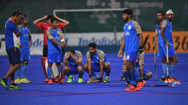 India's players react after losing to Malaysia in the men's field hockey semi-final match. (AFP) India's players react after losing to Malaysia in the men's field hockey semi-final match. (AFP)