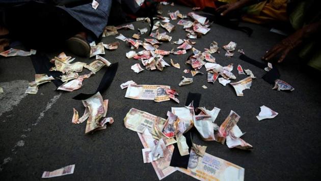 Pieces of old fake 1000 rupee notes lay on the street during a protest, organised by the Congress party, to mark a year since demonetisation was implemented by Prime Minister Narendra Modi.(REUTERS) Pieces of old fake 1000 rupee notes lay on the street during a protest, organised by the Congress party, to mark a year since demonetisation was implemented by Prime Minister Narendra Modi.(REUTERS)