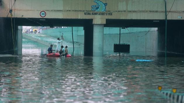 A day after Gurugram received its highest rainfall in a day in the last eight years, the underpass at Hero Honda Chowk remained flooded. Officials of the National Highways Authority of India estimate that 50 million litres of water had accumulated at the underpass following backflow from the stormwater drain at Badshahpur on Tuesday. Officials pressed into service eight fire engines, eight heavy duty pumps, tractor-trolleys and other equipment. (Sanjeev Verma / HT Photo) 