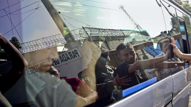 Military police frisk and search passengers travelling on public bus, to search them for weapons or signs that they belong to a gang. Many deported families no longer have a home. They sold everything to pay for a trip north and now find themselves without shelter — and the additional burden of a debt they cannot pay. (Esteban Felix / AP) 