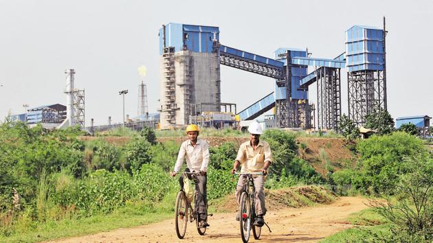 Men ride their bicycles in front of the Bhushan Steel plant in Odissa. (REUTERS File Photo) Men ride their bicycles in front of the Bhushan Steel plant in Odissa. (REUTERS File Photo)