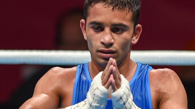 Jakarta: India's Amit Panghal gestures after he was declared winner against Paalam Carlo (unseen) of Philippines in the Men's Light Fly (46-49kg) boxing semifinal bout at the 18th Asian Games 2018.(PTI)