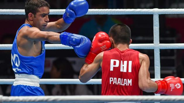India's Amit Panghal (in blue) in action against Paalam Carlo of Philippines during the Men's Light Fly (46-49kg) boxing semifinal bout. (PTI) India's Amit Panghal (in blue) in action against Paalam Carlo of Philippines during the Men's Light Fly (46-49kg) boxing semifinal bout. (PTI)