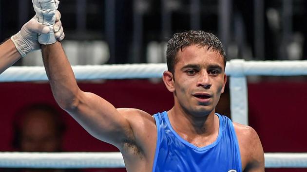 India's Amit Panghal (in blue) is declared winner against Paalam Carlo (unseen) of Philippines in the Men's Light Fly (46-49kg) boxing semifinal bout at the 18th Asian Games 2018 in Jakarta, Indonesia on Friday. (PTI)