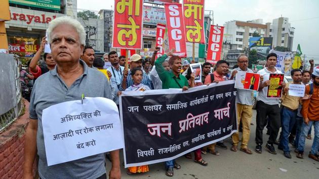 Social activists and filmmakers hold placards during a protest against the raid at activist Stan Swamy's residence, in Ranchi on August 30, 2018. A police team from Maharashtra had also raided social activist Stan Swami’s residence and seized his computer, mobile phone and several documents in connection with the probe into the Bhima-Koregaon violence. (PTI)