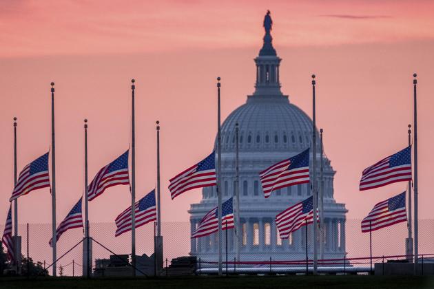 Flags, flying a half-staff in honour of Senator John McCain, frame the US Capitol at daybreak in Washington.(AP File Photo)