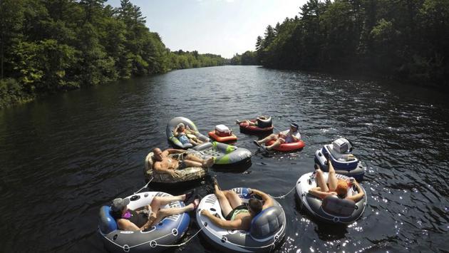 A flotilla of friends from Biddeford, Maine, raft down the Saco River at Bar Mills in Buxton, Maine. (Robert F. Bukaty / AP)
