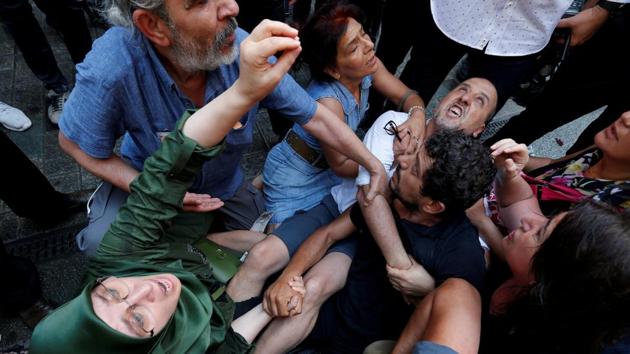 Pro-Kurdish Peoples’ Democratic Party (HDP) lawmakers Huda Kaya and Ahmet Sik scuffle with the police as they prevent Saturday Mothers’ 700th gathering, that meets every week, demanding to know the fate of their missing relatives, claimed to be last seen in the hands of security forces, in central Istanbul, Turkey. (Kemal Aslan / REUTERS)