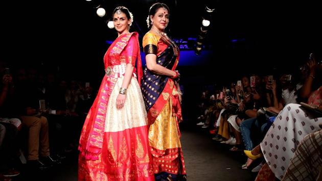Bollywood actress Hema Malini with daughter Esha Deol showcases creations by designer Sanjukta Dutta at the Lakmé Fashion Week Winter Festive in Mumbai, Maharashtra. (PTI) Bollywood actress Hema Malini with daughter Esha Deol showcases creations by designer Sanjukta Dutta at the Lakmé Fashion Week Winter Festive in Mumbai, Maharashtra. (PTI)