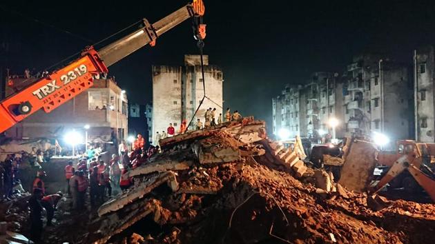 Rescue workers from Ahmedabad Fire & Emergency Services, RSS Volunteers, National Disaster Response Force (NDRF) and Ahmedabad Municipal Corporation staff, work on saving people trapped in the debris of a residential building collapsed in Ahmedabad, Gujarat. (Sam Panthaky / AFP) Rescue workers from Ahmedabad Fire & Emergency Services, RSS Volunteers, National Disaster Response Force (NDRF) and Ahmedabad Municipal Corporation staff, work on saving people trapped in the debris of a residential building collapsed in Ahmedabad, Gujarat. (Sam Panthaky / AFP)