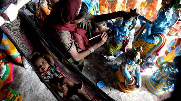 A woman paints a statue of the Hindu god Krishna next to a baby at a workshop ahead of “Krishna Janmashtami” festival, in Chennai, Tamil Nadu. (Arun Sankar / AFP) A woman paints a statue of the Hindu god Krishna next to a baby at a workshop ahead of “Krishna Janmashtami” festival, in Chennai, Tamil Nadu. (Arun Sankar / AFP)