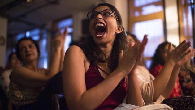 A woman applauds prior to a Femapalooza show in New Delhi. At this women-only comedy show, where punch lines range from breasts and bras to equal pay and censorship, men are strictly banned. They aren’t allowed to attend, perform, or even check tickets at this most recent show. Here, 13 comedians, aged between 17 and 37, tried out their jokes on an audience of around 30 women in an intimate setting. (Noemi Cassanelli / AFP) A woman applauds prior to a Femapalooza show in New Delhi. At this women-only comedy show, where punch lines range from breasts and bras to equal pay and censorship, men are strictly banned. They aren’t allowed to attend, perform, or even check tickets at this most recent show. Here, 13 comedians, aged between 17 and 37, tried out their jokes on an audience of around 30 women in an intimate setting. (Noemi Cassanelli / AFP)