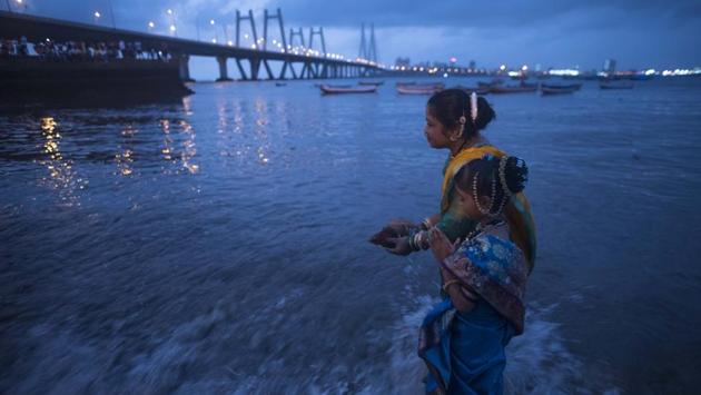 On the full moon day of the Hindu calendar month of Sravan, the Koli community marked Narali Purnima, praying to prevent untoward incidents at sea and appease the sea god, at Worli Koliwada in Mumbai, Maharashtra. (Pratik Chorge / HT Photo) On the full moon day of the Hindu calendar month of Sravan, the Koli community marked Narali Purnima, praying to prevent untoward incidents at sea and appease the sea god, at Worli Koliwada in Mumbai, Maharashtra. (Pratik Chorge / HT Photo)