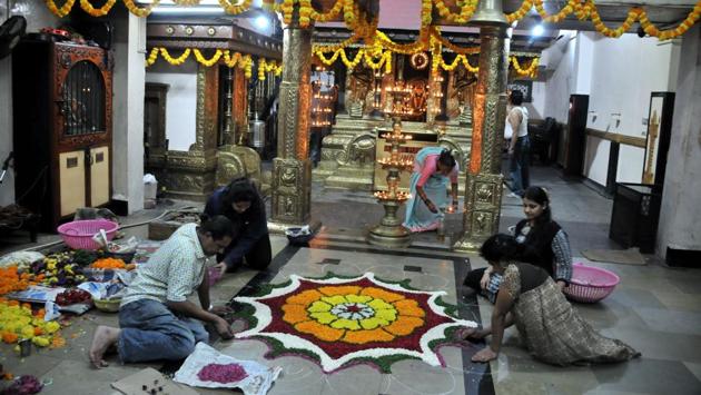 Devotees perform the traditional ritual of laying Pookalam (floral carpet) and decorate the Ayyappa temple in Rasta peth on the eve of the Onam festival on Thursday. (HT PHOTO) Devotees perform the traditional ritual of laying Pookalam (floral carpet) and decorate the Ayyappa temple in Rasta peth on the eve of the Onam festival on Thursday. (HT PHOTO)