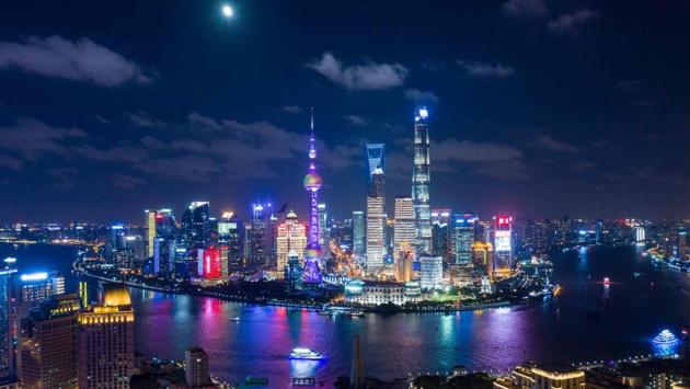 The moon shines over the financial district of Pudong in Shanghai. (Johannes Eisele / AFP)