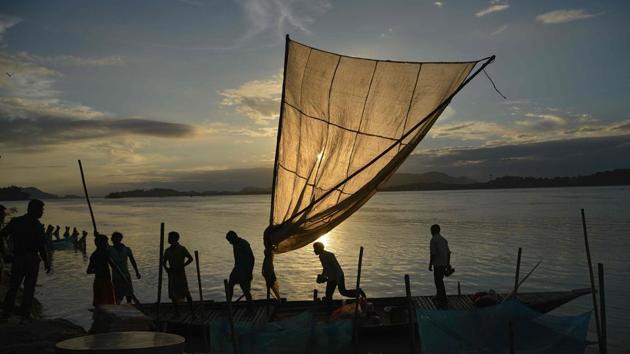 Fishermen load their boat with fish to sell at a market at the banks of the Brahmaputra River at Ujanbazar Ghat in Guwahati, Assam. (Biju Boro / AFP) Fishermen load their boat with fish to sell at a market at the banks of the Brahmaputra River at Ujanbazar Ghat in Guwahati, Assam. (Biju Boro / AFP)