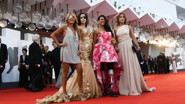 (From L) Italian singer-songwriter and television presenter, Jo Squillo, former Miss Italy contestant and TV presenter, who was left scarred after her ex-boyfriend allegedly threw acid in her face, Gessica Notaro, and paralympic athlete Giusy Versace arrive for the opening ceremony of the 75th Venice Film Festival, and the premiere of the film ‘First Man’, presented in competition at Venice Lido. (Filippo Monteforte / AFP)