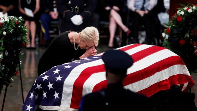 Cindy McCain, wife of late US Senator John McCain, leans over his casket as his body lies in state inside the U.S. Capitol Rotunda in Washington, August 31, 2018.(REUTERS)