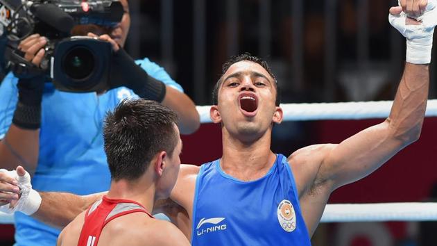 India's Amit Panghal (in blue) gestures after defeating Uzbekistan's Hasanboy Dusmatov during the Men's light fly (46-49kg) boxing final bout. (PTI) India's Amit Panghal (in blue) gestures after defeating Uzbekistan's Hasanboy Dusmatov during the Men's light fly (46-49kg) boxing final bout. (PTI)
