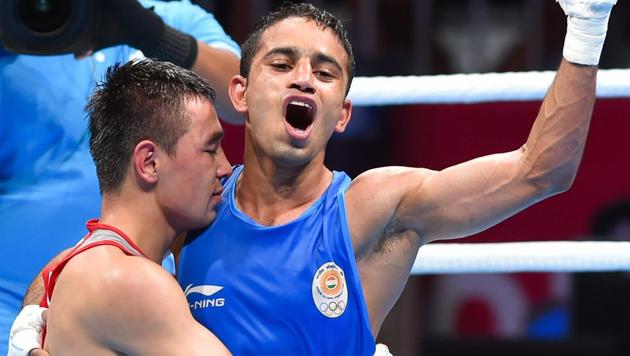 India's Amit Panghal (in blue) gestures after defeating Uzbekistan's Hasanboy Dusmatov at Asian Games 2018.(PTI)