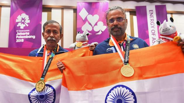 Gold medallist Pranab Bardhan and Shibhnath Sarkar pose with the Indian tricolour after winning in the bridge competition at the 18th Asian Games in Jakarta on Saturday. (PTI) Gold medallist Pranab Bardhan and Shibhnath Sarkar pose with the Indian tricolour after winning in the bridge competition at the 18th Asian Games in Jakarta on Saturday. (PTI)