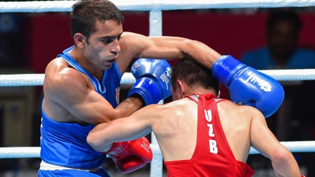 India's Amit Panghal (in blue) in a match against Uzbekistan's Hasanboy Dusmatov during the Men's light fly (46-49kg) boxing final bout at the 18th Asian Games 2018. (PTI)
