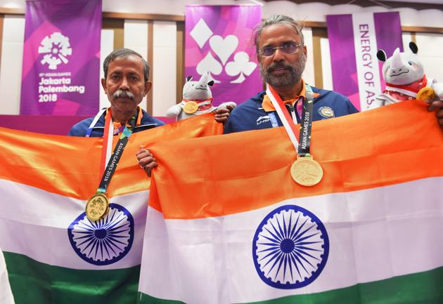Gold medallist India's Pranab Bardhan and Shibhnath Sarkar pose with the Indian tricolour after winning in bridge competition. (PTI) Gold medallist India's Pranab Bardhan and Shibhnath Sarkar pose with the Indian tricolour after winning in bridge competition. (PTI)