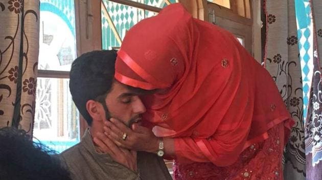 A relative kisses Nisar Ahmad after his release by militants in south Kashmir’s Midoora village of Awantipora in Pulwama district of Jammu & Kashmir on Saturday.(Waseem Andrabi/HT Photo)