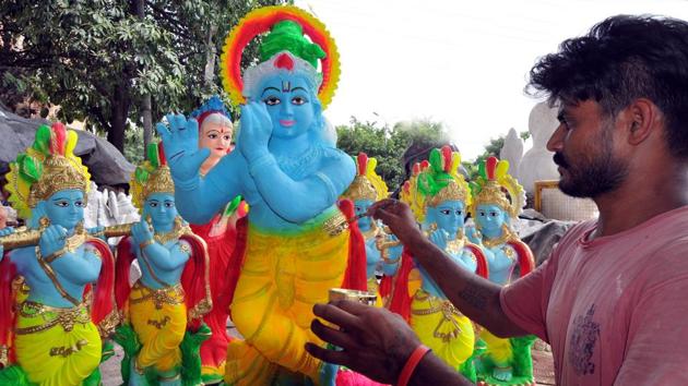 An artist giving final touches to the idols of Lord Krishna in Jalandhar. (Pardeep Pandit/ht)