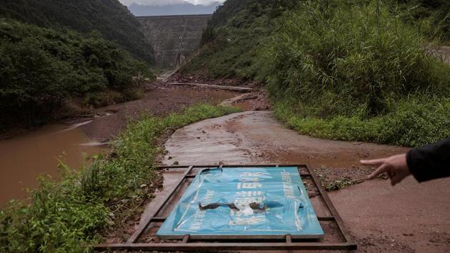 A sign for a fish breeding base under one of the dams on the Zhougong. On the 48 km river, authorities have already demolished small projects built in nature reserves or encroaching upon new “ecological red lines”. But the river houses 10 larger stations run by some of the country’s biggest firms, including Guodian, Huadian and the State Grid Corp. (Damir Sagolj / REUTERS)