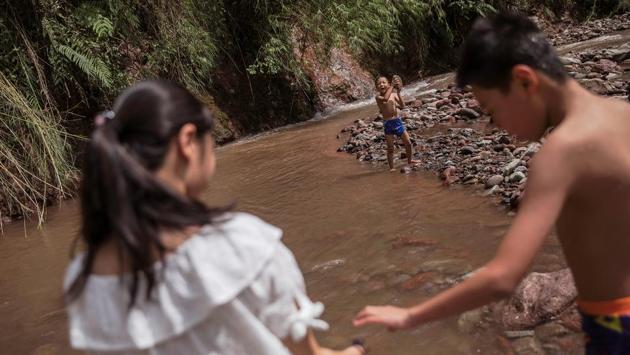 Children cool themselves in one of the tributaries of Zhougong River near Ya’an. In June, state auditors identified 24,100 small hydropower projects in the 11 regions along the Yangtze, and said the environmental costs of some plants were too high even though they had made “historical contributions” to development. (Damir Sagolj / REUTERS)