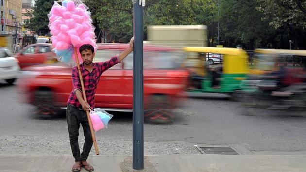 A street vendor sells cotton candy at a busy traffic junction in Bangalore, Karnataka. (Manjunath Kiran / AFP) A street vendor sells cotton candy at a busy traffic junction in Bangalore, Karnataka. (Manjunath Kiran / AFP)