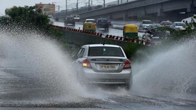 Sights like this of vehicles splashing water through flooded streets were observed all over. The traffic police also asked people to avoid the Delhi-Noida road towards Ashram where traffic was blocked after a bus broke down, under Hanuman Setu on the Ring Road, Punchkuyan Road, Bhairon Road where traffic was barred on both sides, Mathura Road, Purana Quila Road, Teen Murti Marg and several other stretches. (Mohd Zakir / HT Photo) 