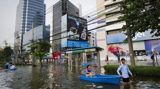 A woman being ferried on a boat in the flooded section of Bangkok, when the year's monsoon season brought the worst floods in decades with a fifth of the city under water in November 2011. A World Bank report predicts that nearly 40% of Bangkok will be inundated by as early as 2030 due to extreme rainfall and changes in weather patterns. (AFP File Photo) A woman being ferried on a boat in the flooded section of Bangkok, when the year's monsoon season brought the worst floods in decades with a fifth of the city under water in November 2011. A World Bank report predicts that nearly 40% of Bangkok will be inundated by as early as 2030 due to extreme rainfall and changes in weather patterns. (AFP File Photo)