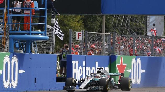 Checkered flag is waved as Mercedes driver Lewis Hamilton of Britain crosses the finish line during the Formula One Italy Grand Prix at the Monza racetrack, in Monza.(AP) Checkered flag is waved as Mercedes driver Lewis Hamilton of Britain crosses the finish line during the Formula One Italy Grand Prix at the Monza racetrack, in Monza.(AP)