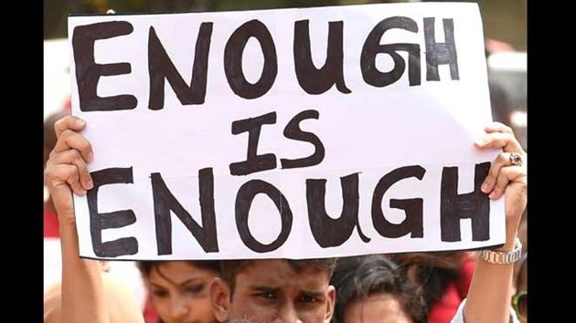 Activists hold placards during a rally to protest against incidents of sexual abuse, molestation and rapes against women in Bangalore.(AP File Photo)
